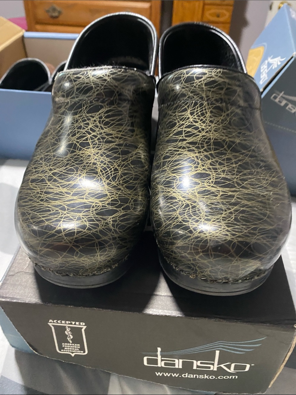 Dansko Black and Gold Patterned Clogs